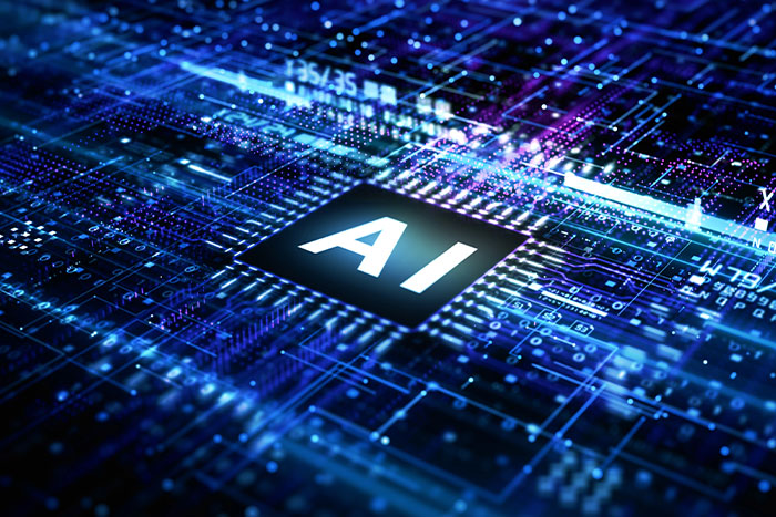 Close-up of a digital circuit board with "AI" in the center.