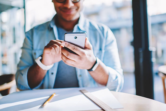 Image of a man using a smartphone.